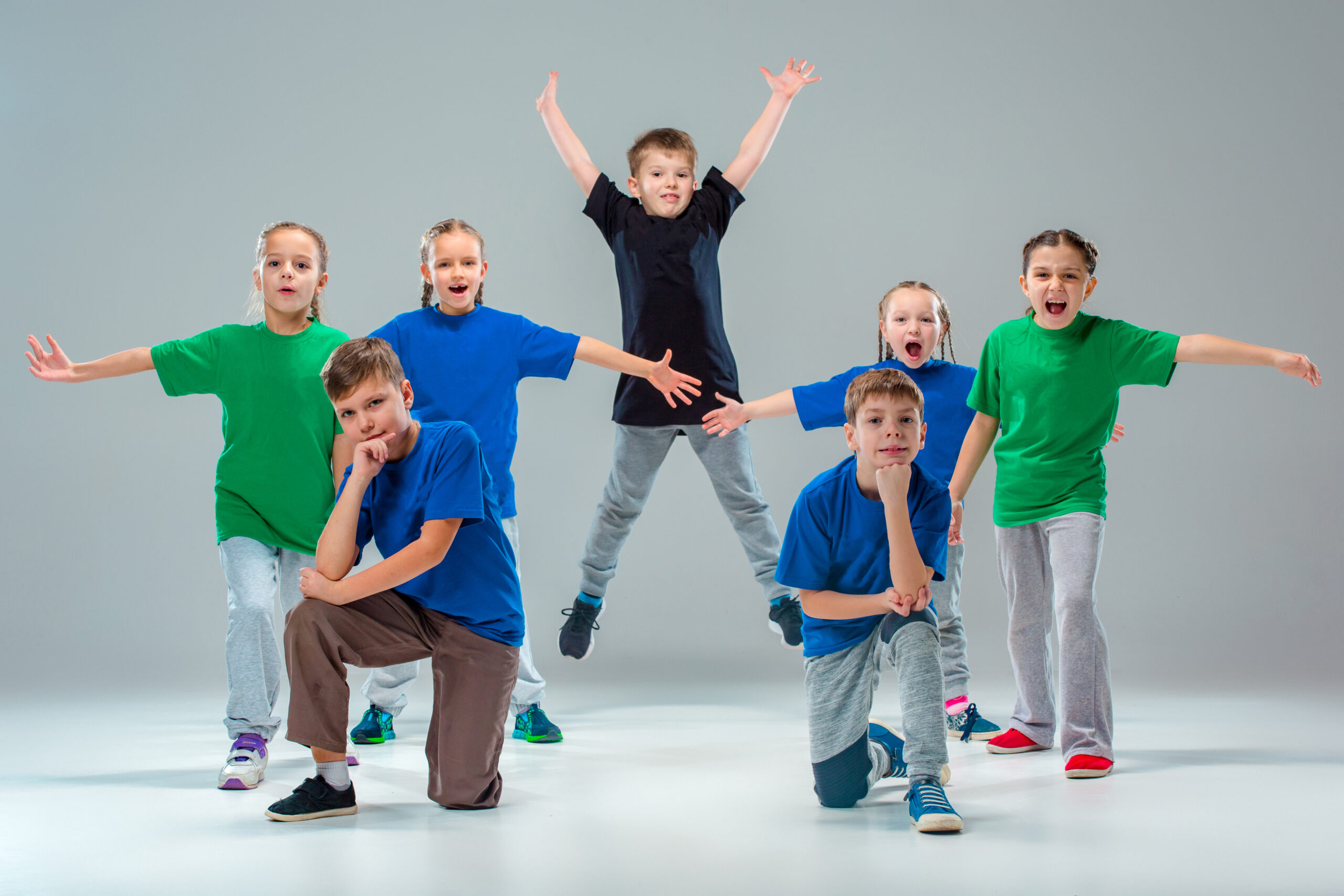 The kids dance school, ballet, hiphop, street, funky and modern dancers The kids dance school, ballet, hiphop, street, funky and modern dancers on gray studio background